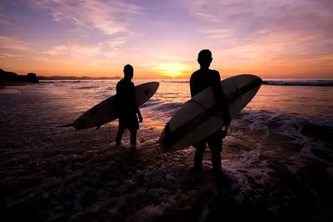 Surfing at sunset